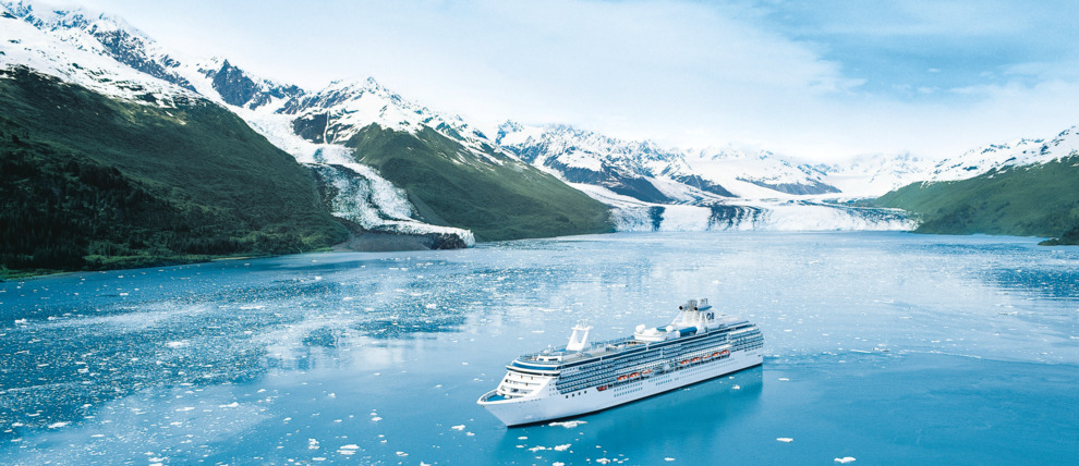 Princess Cruises Coral Princess cruising in front of a glacier in Alaska.