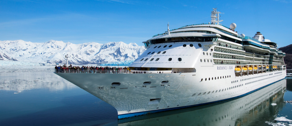 Royal Caribbean Cruises Radiance of the Seas cruising in front of a glacier in Alaska.