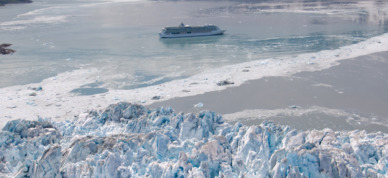 Royal Caribbean Cruises Serenade of the Seas cruising in front of a glacier in Alaska.
