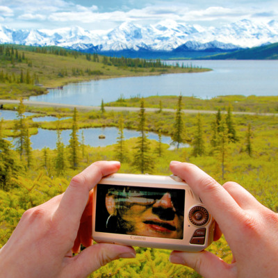 Visitor taking a photo at Wonder Lake in Denali National Park. 
