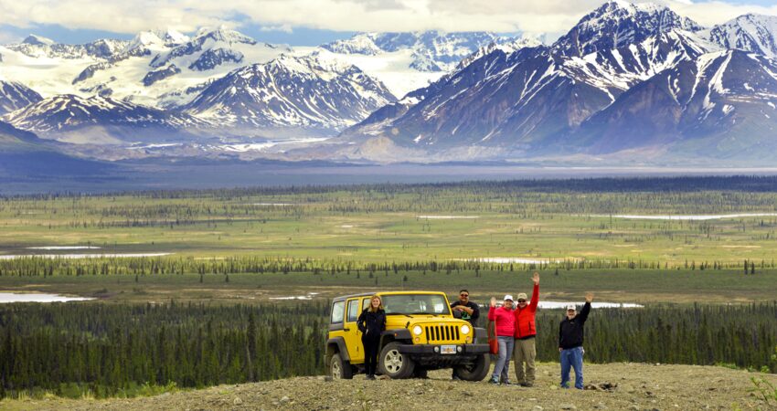Jeep group stops for a photo in front of the Alaska Range.