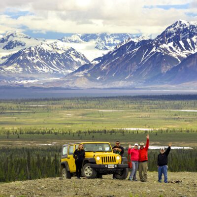 Jeep group stops for a photo in front of the Alaska Range.