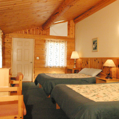 Tradition cabin featuring two beds. 