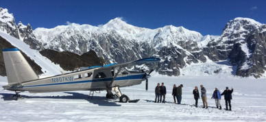 Group posing for a photo on a glacier.