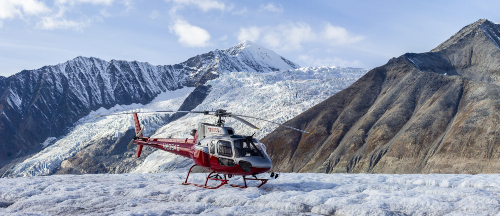 Helicopter landing on Yanert Glacier in the Alaska Range.