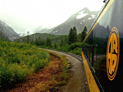 Alaska Railroad train turning the bend on a rainy afternoon.