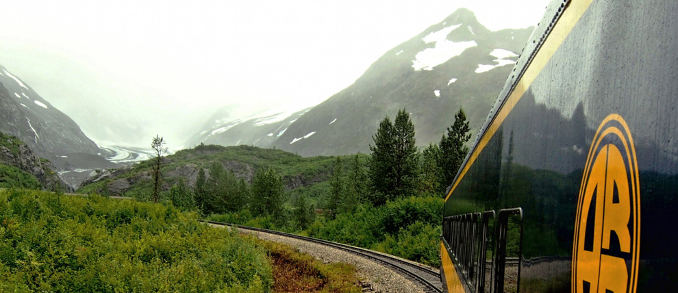 Alaska Railroad train turning the bend on a rainy afternoon.