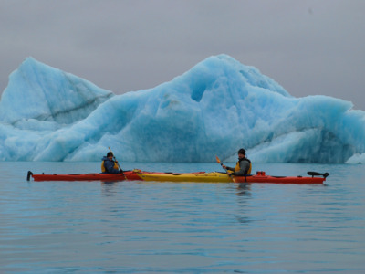 Two kayakers pose near Bear Glacier in Kenai Fjords National Park. Two kayakers pose near Bear Glacier in Kenai Fjords National Park.