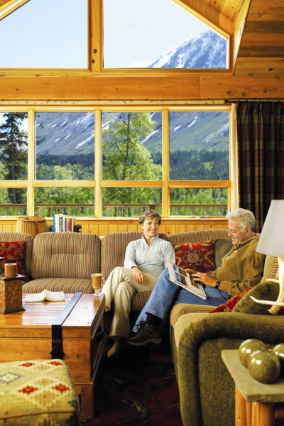 Guests enjoying lobby mountain views at Kenai Princess Lodge.