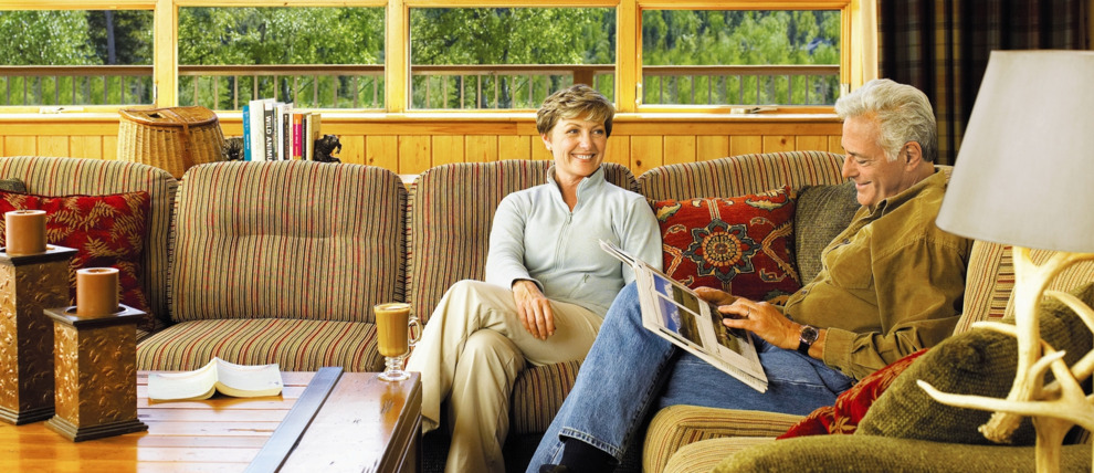 Guests enjoying lobby mountain views at Kenai Princess Lodge.