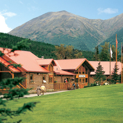 Kenai Princess main lodge against mountain background.