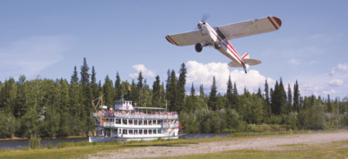 Watch a small plane take off next to Riverboat Discovery.