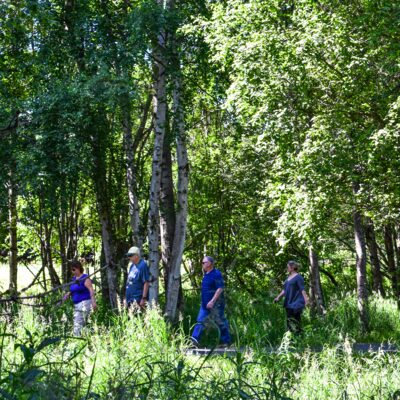 Visitors take a stroll on Anchorage's Coastal Trail.