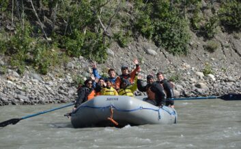 Guests waving for the camera along the Nenana river.