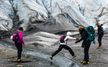 Hopping creeks on the Root Glacier near McCarthy, Alaska.