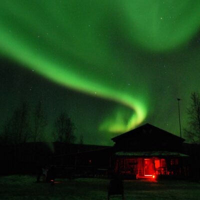 Northern lights dance above the Arctic Circle Trading Post.