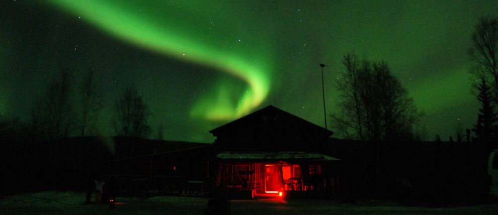 Northern lights dance above the Arctic Circle Trading Post.