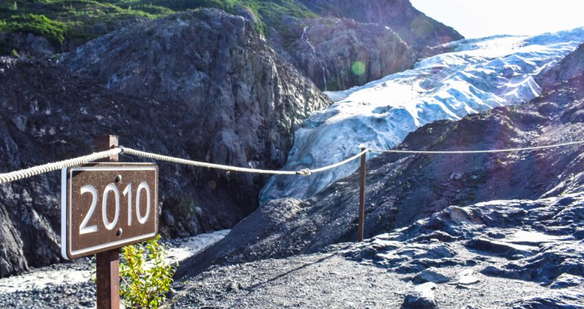 Trail markers show where the toe of the glacier reached in a given year.