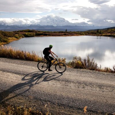 Biking along the Denali Park Road with views of Denali.