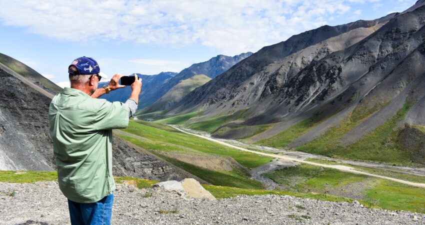 Traveler enjoys the views at Atigun Pass in the Brooks Range.