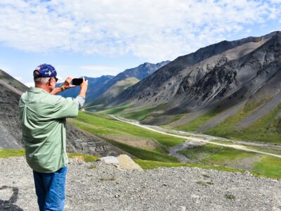 Traveler enjoys the views at Atigun Pass in the Brooks Range. Traveler enjoys the views at Atigun Pass in the Brooks Range.