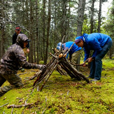 Constructing a simple shelter, a critical survival skill.